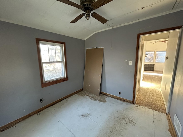 unfurnished bedroom featuring ceiling fan, vaulted ceiling, and multiple windows