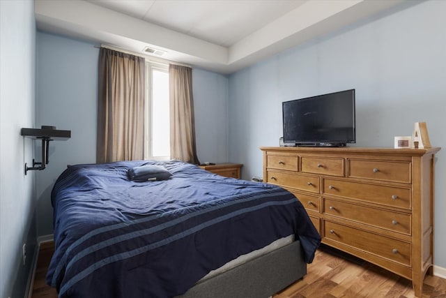 bedroom with wood-type flooring