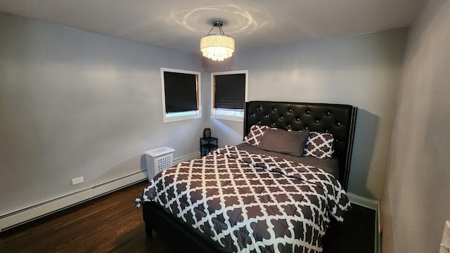 bedroom featuring a notable chandelier, a baseboard radiator, and dark wood-type flooring