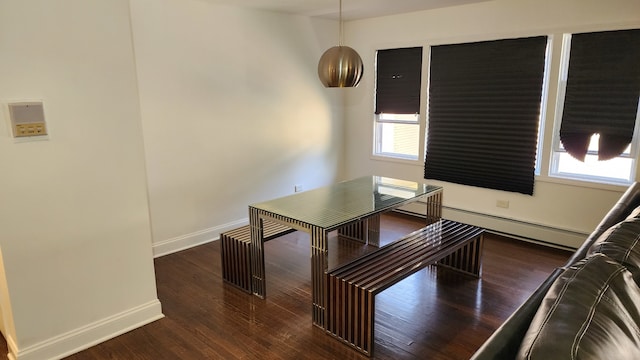 dining space with dark hardwood / wood-style flooring and a baseboard radiator