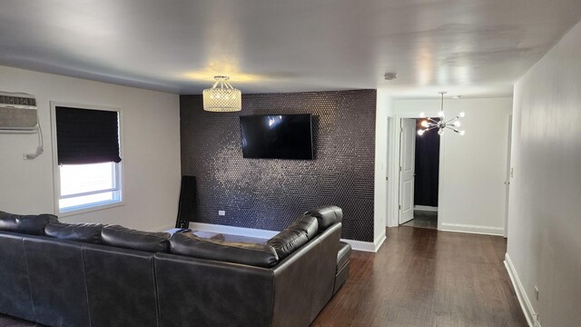 824 N Austin Blvd Unit 3E, Oak Park, IL 60302 - living room with dark wood-style floors, baseboards, an AC wall unit, and a chandelier