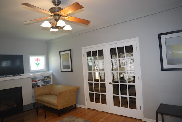 1040 N Austin Blvd, Oak Park, IL 60302 - sitting room with a fireplace, wood finished floors, baseboards, and ceiling fan