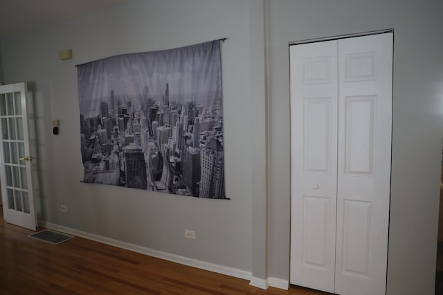 unfurnished bedroom featuring dark hardwood / wood-style flooring and a closet