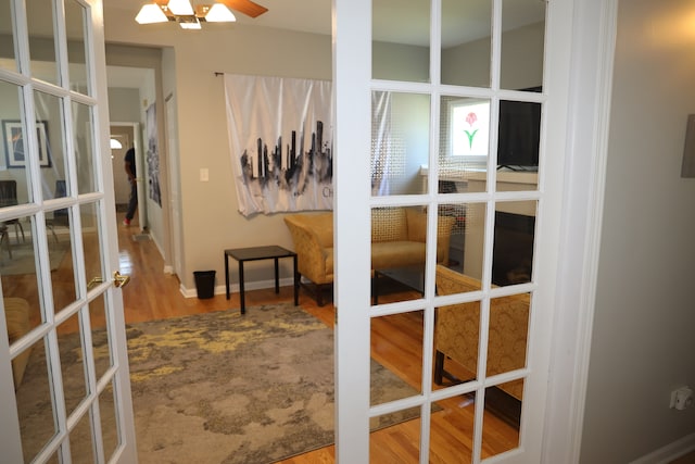 bedroom with hardwood / wood-style floors and french doors