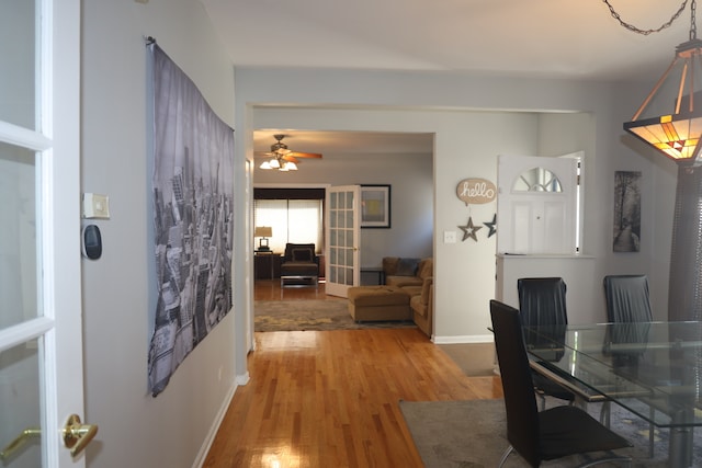 dining space featuring wood-type flooring and ceiling fan