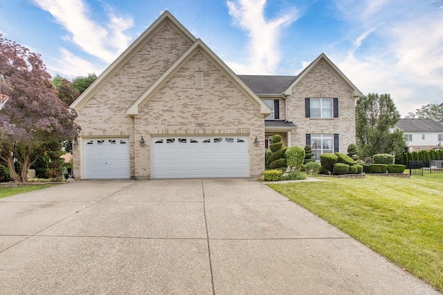 view of front of property with a garage and a front lawn