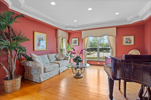 living room featuring light wood-type flooring and crown molding