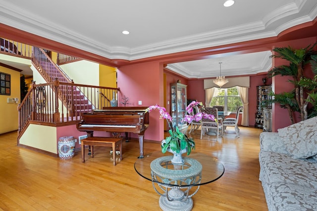 living room featuring light wood-type flooring and crown molding