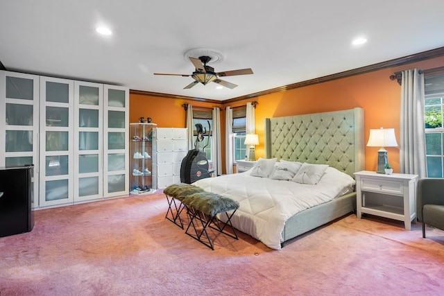 bedroom with ceiling fan, crown molding, and carpet flooring