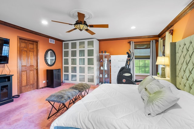 bedroom featuring carpet floors, ornamental molding, and ceiling fan