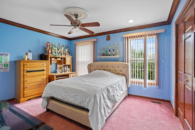 bedroom with ornamental molding, ceiling fan, a closet, and carpet