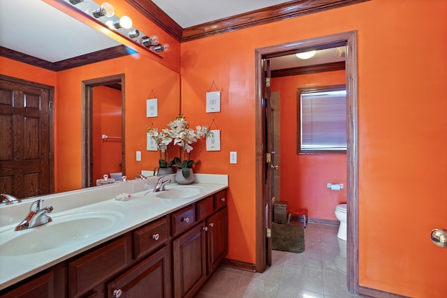 bathroom featuring toilet, tile patterned floors, crown molding, and vanity