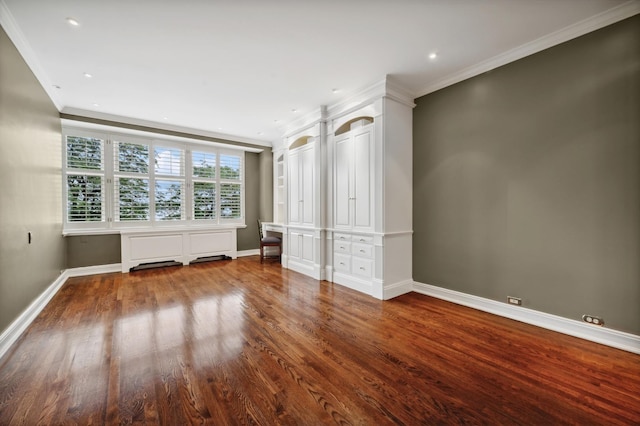 unfurnished bedroom with wood finished floors, baseboards, and ornamental molding