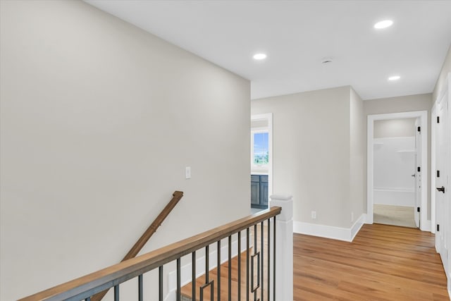 corridor with light hardwood / wood-style flooring