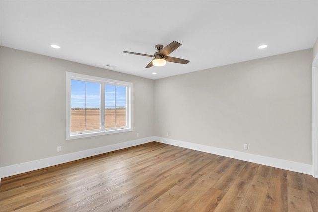 spare room with wood-type flooring and ceiling fan