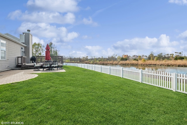 view of yard with a patio area and a water view