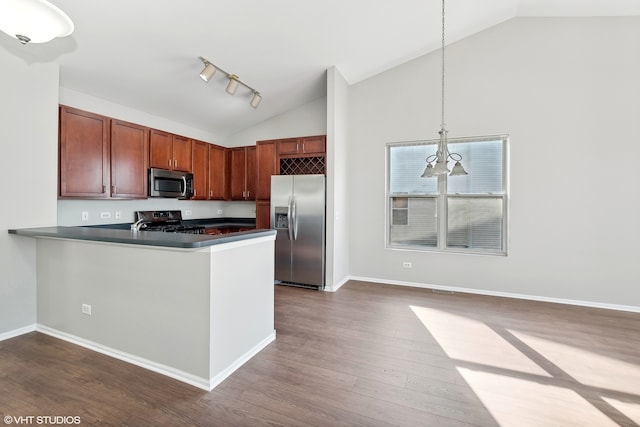 kitchen featuring hanging light fixtures, dark hardwood / wood-style floors, kitchen peninsula, and appliances with stainless steel finishes