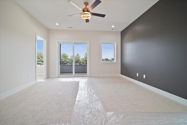 carpeted empty room with ceiling fan