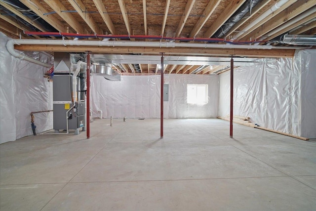 basement featuring heating unit and electric panel