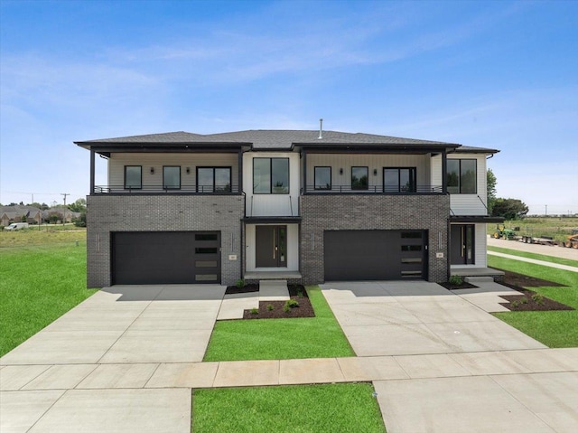 view of front of home with a garage, a front lawn, and a balcony