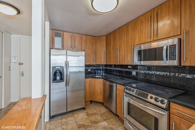 kitchen with stainless steel appliances, sink, tasteful backsplash, and light tile patterned floors