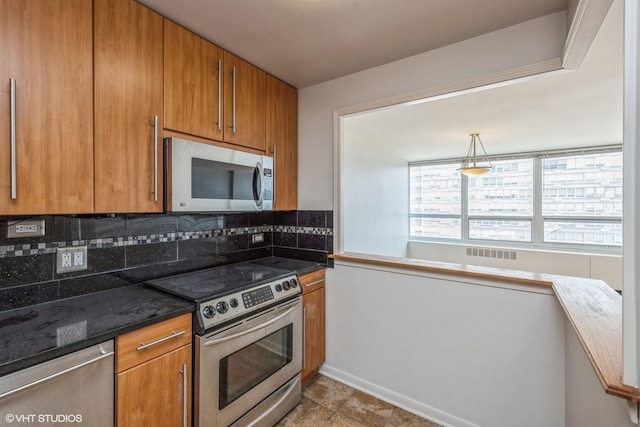 kitchen with stainless steel appliances, visible vents, brown cabinets, decorative backsplash, and dark stone countertops