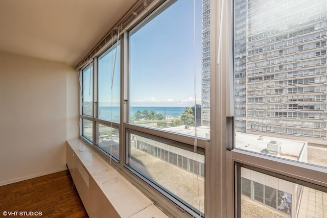 sunroom / solarium with a water view