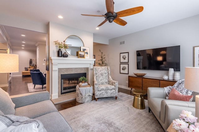 living room with ceiling fan and dark hardwood / wood-style flooring