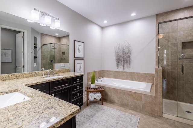 bathroom with tile patterned flooring, vanity, and plus walk in shower