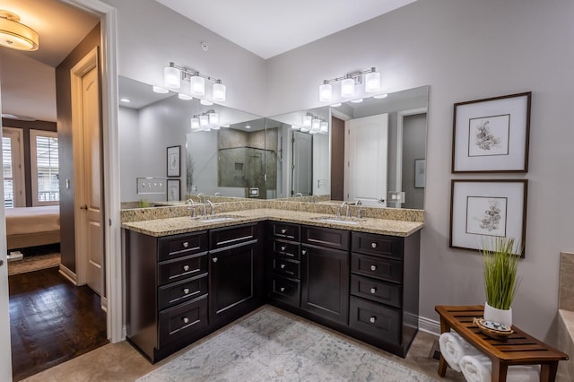 bathroom featuring hardwood / wood-style flooring, vanity, and a shower with door