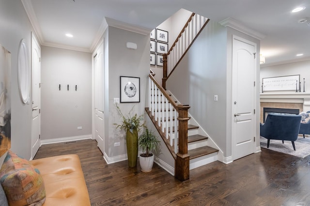 stairs with crown molding and hardwood / wood-style flooring