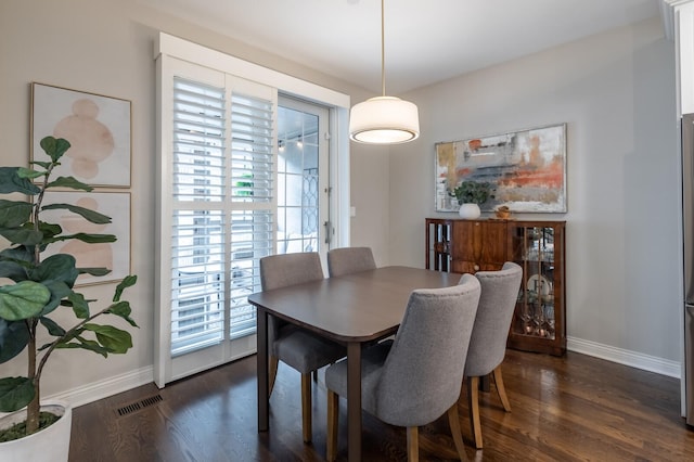 dining area with dark hardwood / wood-style floors