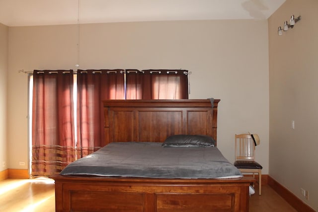 bedroom featuring baseboards and wood finished floors