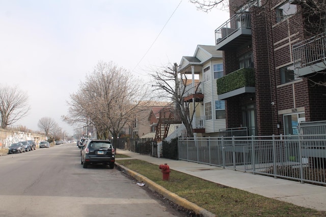 view of street with curbs, sidewalks, and a residential view