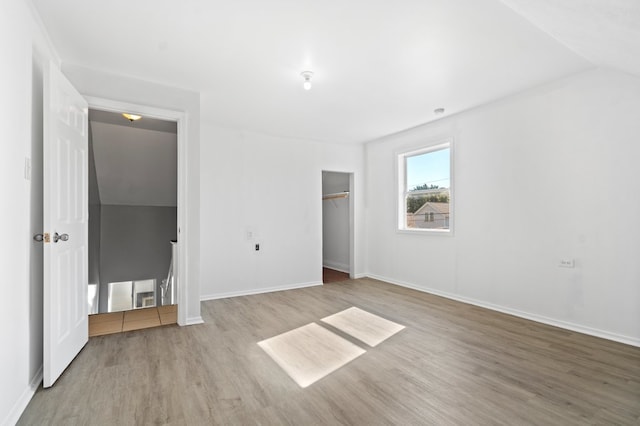 interior space featuring light hardwood / wood-style floors and vaulted ceiling