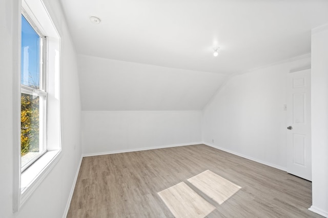 bonus room featuring light wood-type flooring and lofted ceiling