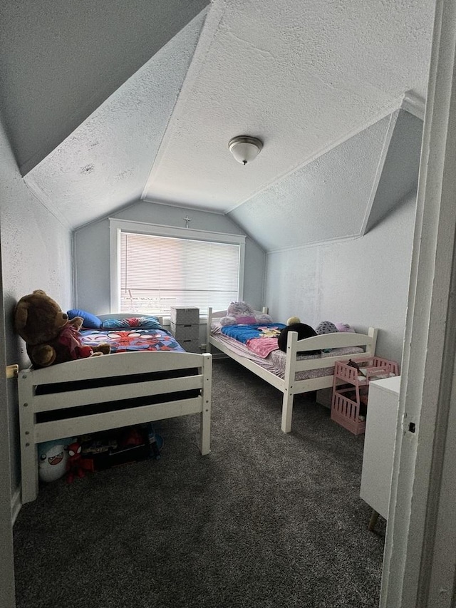 carpeted bedroom with a textured ceiling and vaulted ceiling