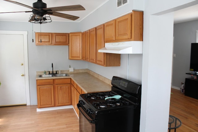 kitchen featuring light wood-type flooring, sink, ceiling fan, and black range with gas cooktop