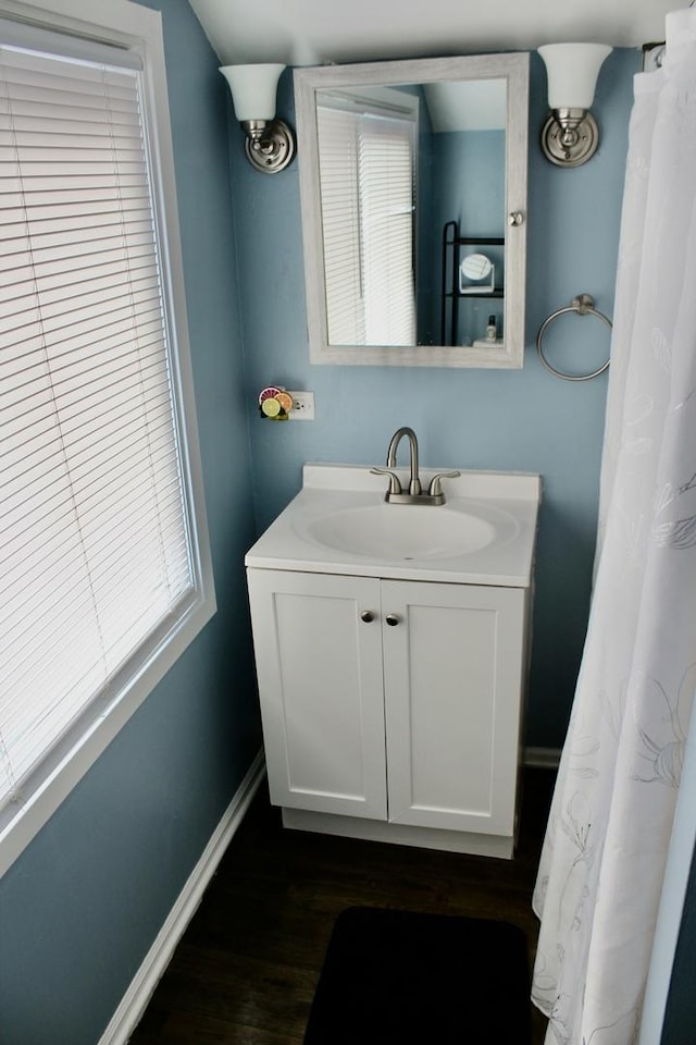 bathroom with hardwood / wood-style floors and vanity