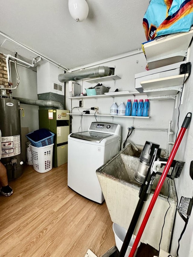 laundry room with light hardwood / wood-style floors, washer / dryer, sink, and gas water heater