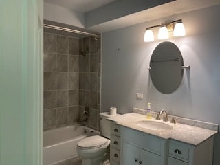 full bathroom featuring vanity, toilet, and tiled shower / bath