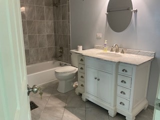 full bathroom with toilet, vanity, and tiled shower / bath combo