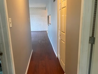 hallway featuring dark wood-type flooring