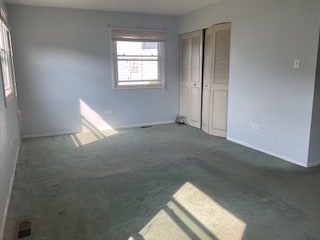 unfurnished room with dark carpet