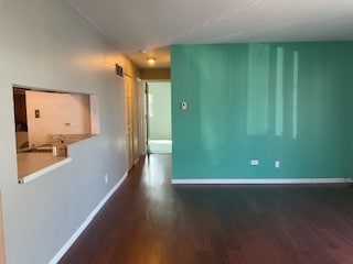 spare room with wood-type flooring