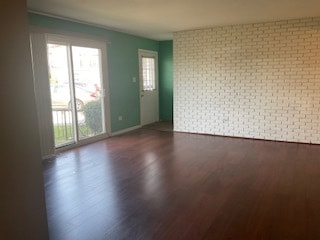 spare room with dark wood-type flooring