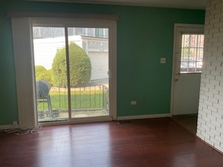 doorway to outside with wood-type flooring