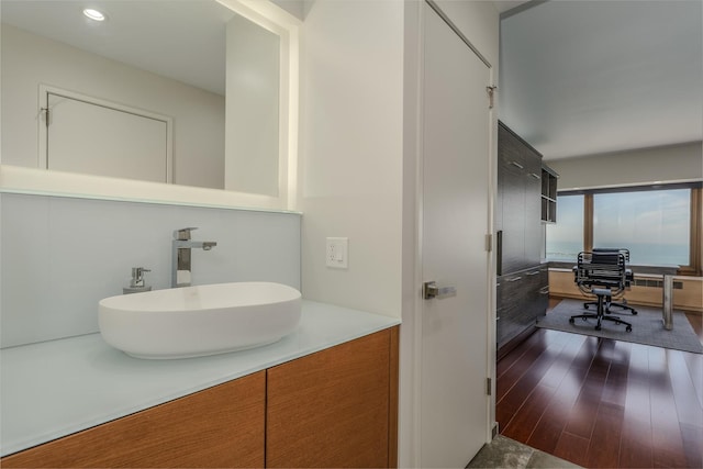 bathroom with vanity and hardwood / wood-style flooring