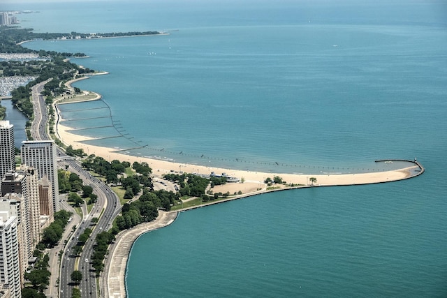 drone / aerial view with a beach view and a water view