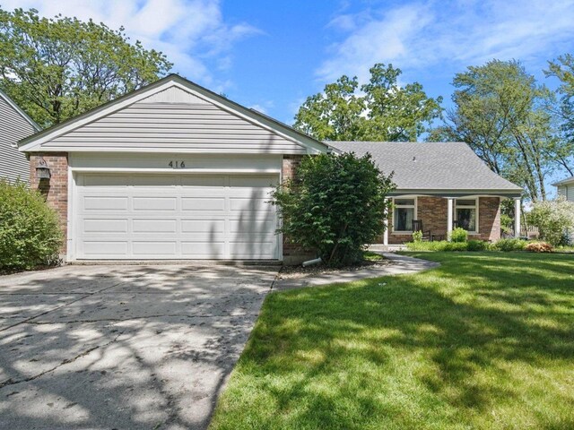 single story home with a garage and a front lawn